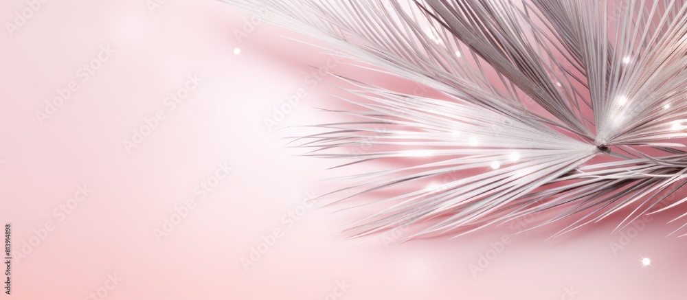 Poster top view copy space image of a sparkling silver palm branch adding a festive touch to the pastel pin