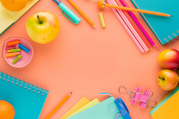 Colorful school supplies like pencils, crayons, and notebooks sprawl across a desk ready for a creative back-to-school year
