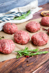 Beef raw meatballs on wooden background 