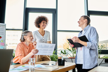 Fototapeta premium Group of hard-working, diverse businesswomen brainstorming around a table in a coworking space.