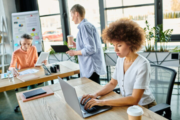 Obraz premium Women engrossed in work, at table in stylish setting.