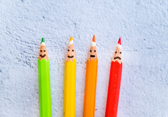 Pencils with sad and smiling faces . Survey  concept 