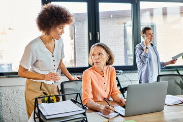 Fototapeta premium Interracial businesswomen working together in office.