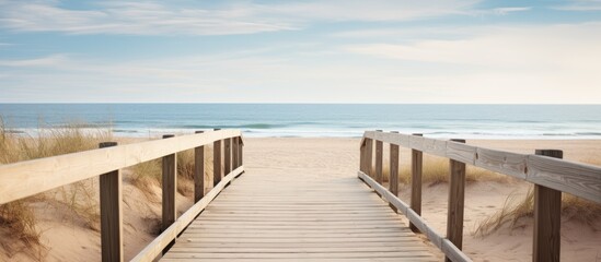 A wooden boardwalk meanders through the sandy beach providing a scenic route with plenty of copy space image potential