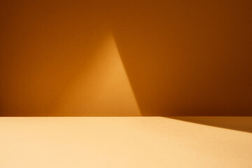 Empty table with light reflection on dark brown wall. Mock up for branding products, presentation,...