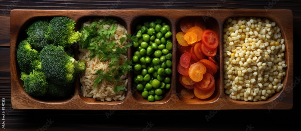Poster a top down view of a wooden kitchen tray displaying a combination of frozen raw vegetables and quino