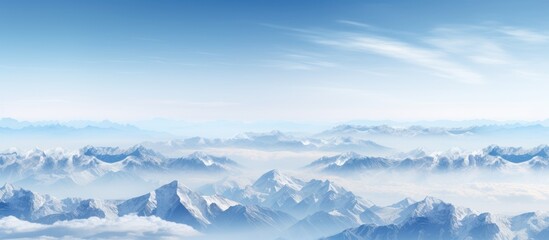 Mountainous terrain at high elevations depicted against a picturesque backdrop of a clear blue sky providing ample space for including images