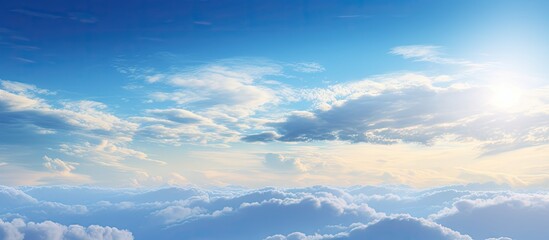 Obraz premium In the morning a stunning sunrise illuminates a lovely blue sky dotted with a group of white fluffy clouds creating a picturesque natural background for a copy space image