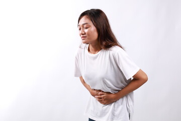 Young asian Woman has stomachache isolated over white background with copyspace