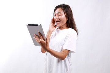 Surprised young millennial asian woman looking at digital tablet screen, received unexpected news,...