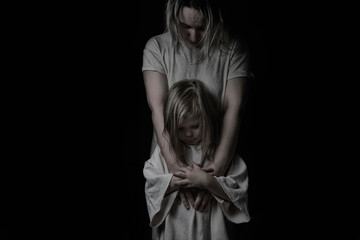 little daughter and mother are sad on a black background