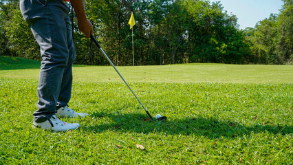 Golfer are playing game golf and hitting go on green grass mountain background.