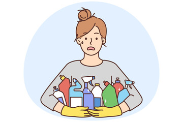 Stressed woman with detergent bottles
