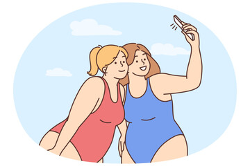 Overweight women in bikinis make selfie