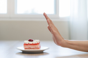 Diet asian young woman, girl hand push out, refuse eat piece chiffon strawberry layers cake, sweet...