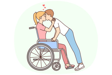 Man kissing disabled woman in wheelchair