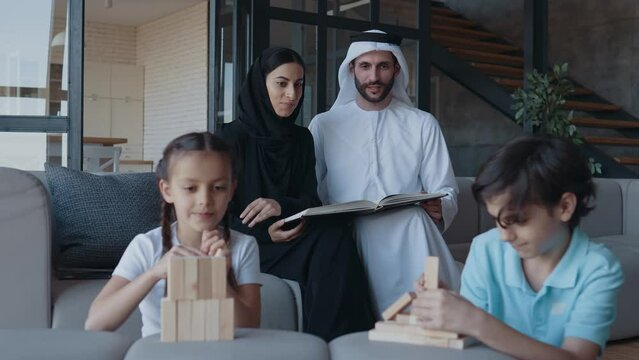 Traditional arabian family from Dubai spending time together at home. Concept about, emirati culture, parenthood, adoption and  family lifestyle