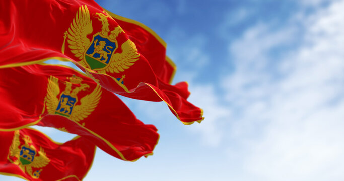 National flags of Montenegro waving in the wind on a clear day