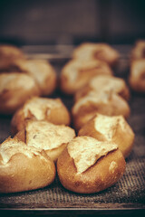 Freshly baked buns on the baking tray in a bakery