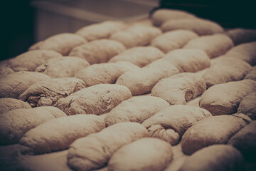 Bread blanks on large baking sheets, prepared for baking in a bakery