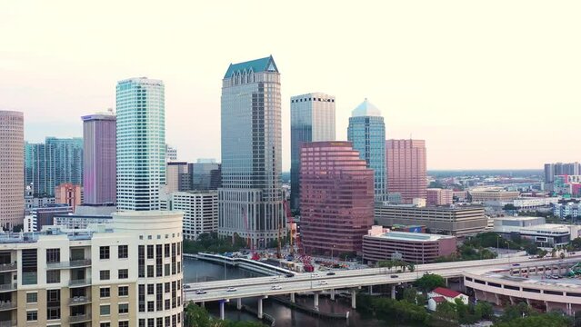 Descending aerial view of Tampa, Florida skyline early morning sunrise.