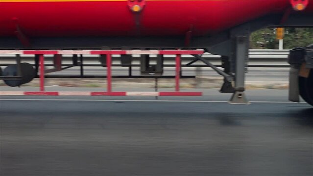 View of the wheels of a cistern truck while driving on a highway