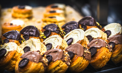 Round puff pastry pies with white and dark chocolate, nuts and pistachios