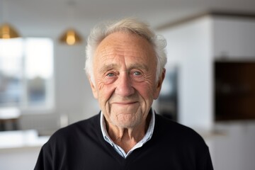 Portrait of a smiling man in his 80s smiling at the camera isolated in modern minimalist interior