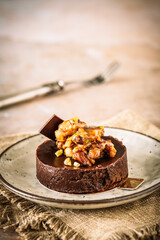 Tartlet made from crispy dough with apple and sprinkles and a topping of white cream, vertical with copy space