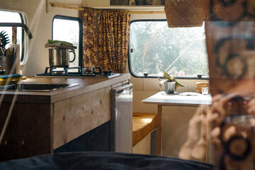 Interior in a caravan. Kitchen in the trailer. Motor home at sunset. © Olha