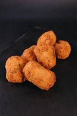 Homemade croquettes with black background