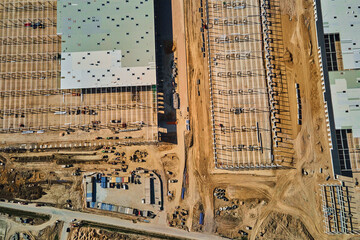 Aerial view of construction site with warehouse building under construction for storage. Assembling...