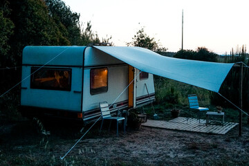 trailer of mobile home.  camping life. Caravan in sunset