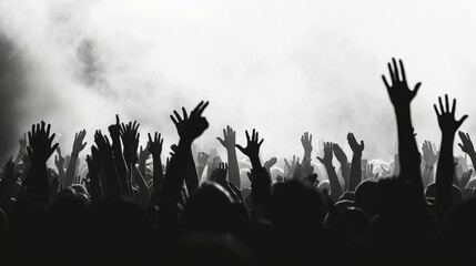 Silhouettes of people with hands raised in a crowd, possibly at a concert or gathering, monochrome image. - Powered by Adobe
