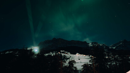 Aurora Brilliance: Snowy Peaks Bathed in Northern Lights