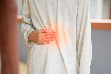 Man white shirt hand touching stomach due to abdominal pain caused gastritis or enteritis and...