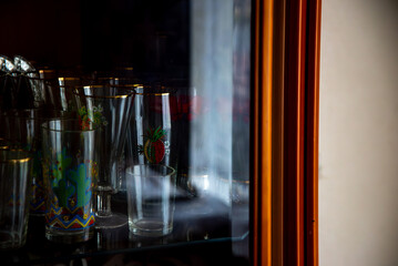 a brown corner where you can see juice glasses behind the glass