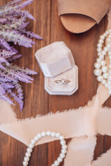 A flat lay of a wedding ring and wedding accessories.