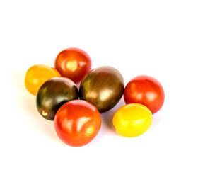 colorful cherry tomatoes isolated on white background (cut out small tomato food ingredient) red yellow green brown tiny grape sized close up macro