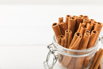 Cinnamon sticks on a textured wooden background. Cinnamon roll. Spicy spice for baking, desserts and drinks. Fragrant ground cinnamon. cinnamon powder Close-up. Place for text. copy space