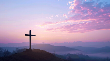 A serene dawn sky with soft pastel colors as the backdrop for a silhouetted Christian cross on a...