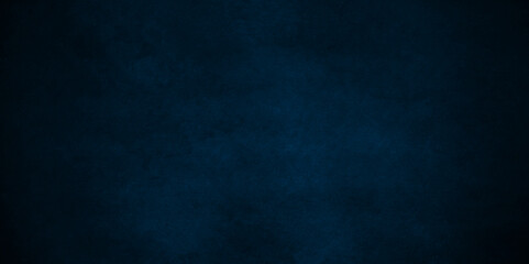 Dark blue stone wall blank backdrop light design. Dark blue or black slate background rock distress texture. High Resolution on dark black and blue Cement Texture Background.