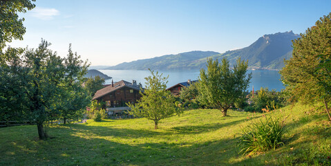 idyllic landscape tourist resort krattigen with traditional houses, view to lake Thunersee