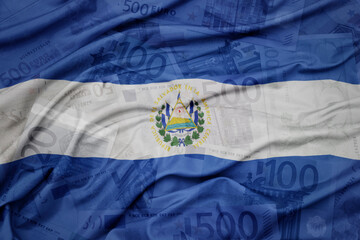 waving colorful national flag of el salvador on a euro money banknotes background. finance concept.