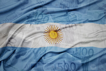 waving colorful national flag of argentina on a euro money banknotes background. finance concept.