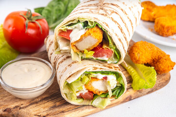 Fried chicken wraps with nuggets, fresh vegetables and buttermilk ranch sauce, healthy balanced...