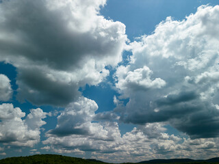 Big white fluffy clouds in the blue sky.Summer background. - Image	
