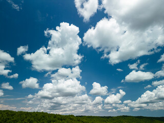 Big white fluffy clouds in the blue sky.Summer background. - Image	
