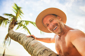 nice man taking selfie portrait on beach