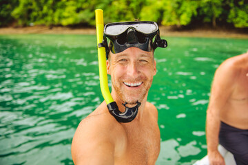 snorkeling men having great time on boat